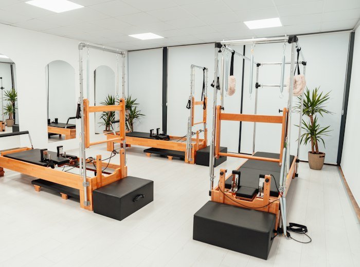The empty studio with wooden reformers and plants
